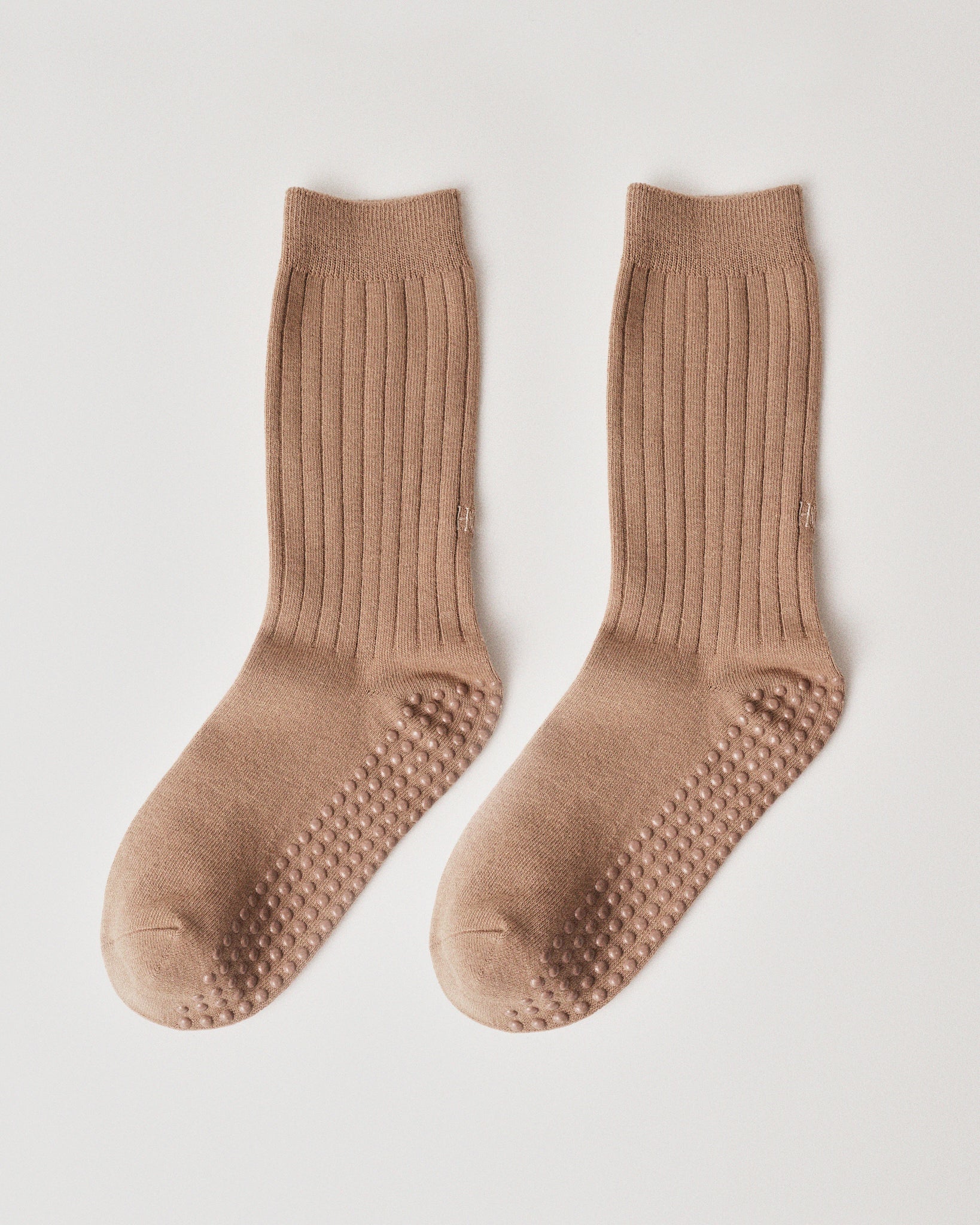 Pair of sand socks with grip sole on a wight background